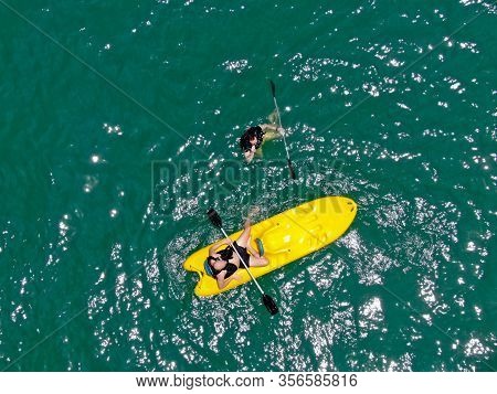 Aerial View View Of Strong Young Active Men Capsizing With Their Kayak On The Clear Blue Turquoise W