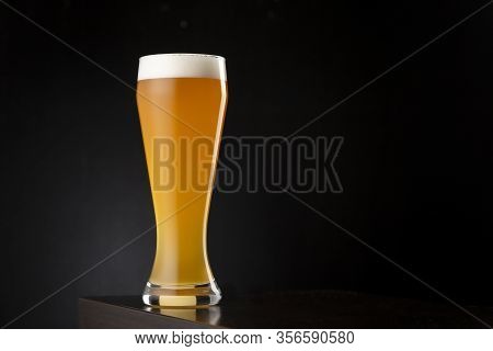 Glass Of Cold Unfiltered Wheat Beer On A Bar Counter