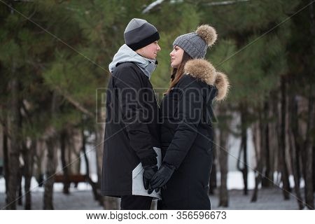 Beautiful Family, Man And Woman In The Woods In Winter.