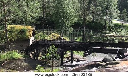 Waterfall At Old Watermills In The Forest, Norway.