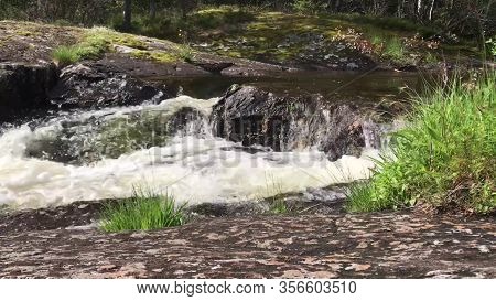 Waterfall Springing From The Mountain River At Scandinavian Forest In Norway.