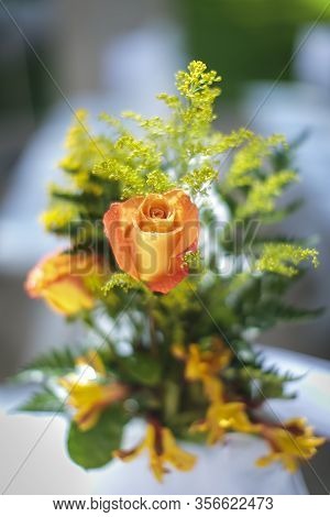 Yellow And Pink Rose With Soft Green Filler In The Background For A Wedding Decoratioin
