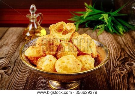 Cooked Brazilian Cheese Bread Chipa In Bowl On Wooden Background.