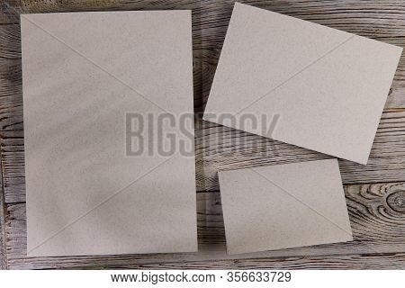 Mosk Up. Abstract Background. Three Cards Of Different Sizes On A Wooden Surface. Texture Of Paper A