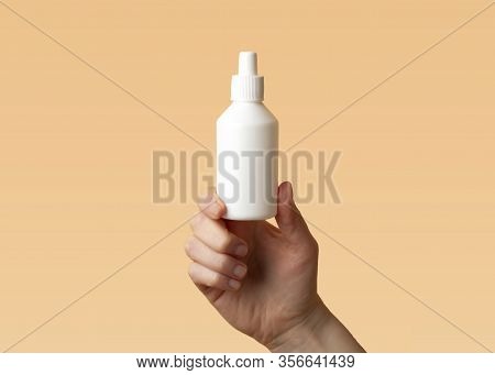 Viral Disease Prevention Concept. Female Hand Holds A Plastic Bottle With Antiseptic Chloroxylenol O