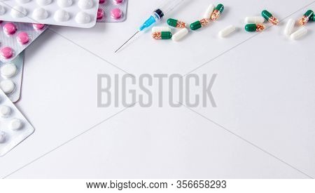 Coronavirus Phrase Text On A White Background With Medicines And Pills. The Concept Of The New 2019 