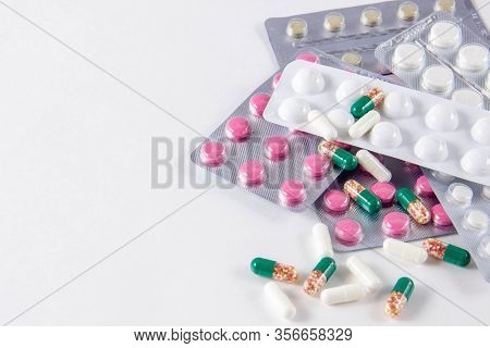 Coronavirus Phrase Text On A White Background With Medicines And Pills. The Concept Of The New 2019 