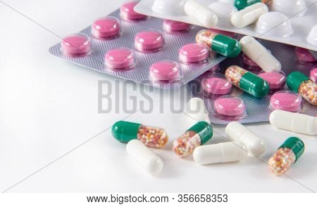 Coronavirus Phrase Text On A White Background With Medicines And Pills. The Concept Of The New 2019 