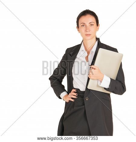 A Business Woman In A Black Suit Holding On A Computer Notebook. Portrait On White Background With S