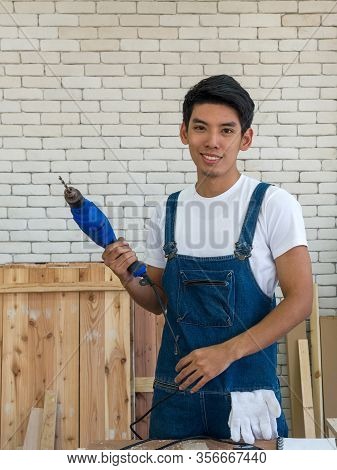 Asian Carpentry Poses Confidently Before Beginning The Job Of Receiving Orders At The Wood Working P