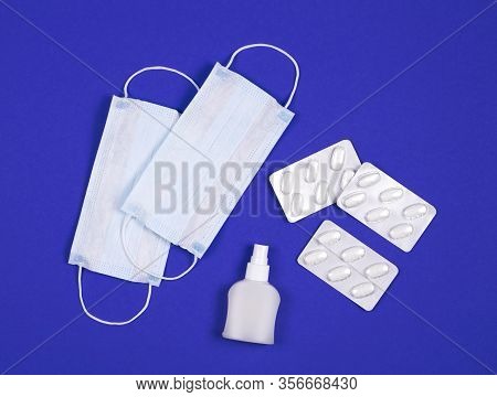 P Revention Of C Oronavirus. Medical Masks, Vitamins, Antiseptic On A Blue Background.