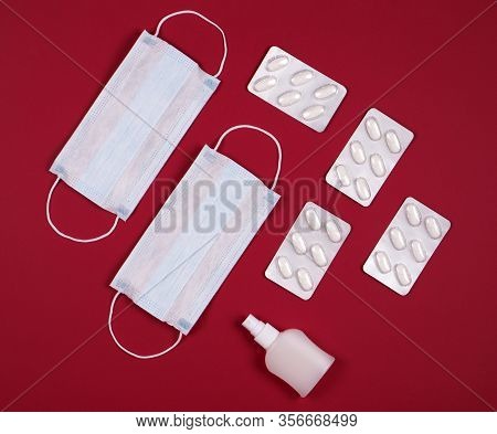 P Revention Of C Oronavirus. Medical Masks, Vitamins, Antiseptic On A Red Background.