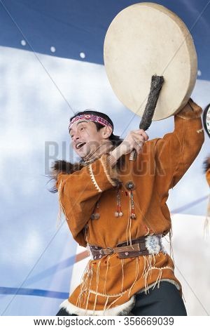 Aboriginal Dancer In National Clothes Of Native People Emotional Dancing With Tambourine. Concert Ko