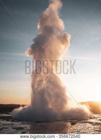 Famous Geysir In Iceland In Beautiful Sunset Light. One Of The Most Famous Natural Heritage On Icela