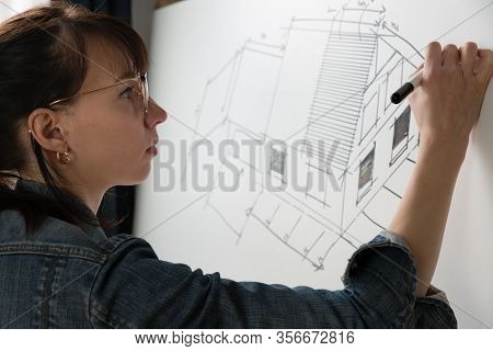 Close-up Of A Young Female Architect Drawing A Sketch For A New Famaly Home Project. Concept Of Work