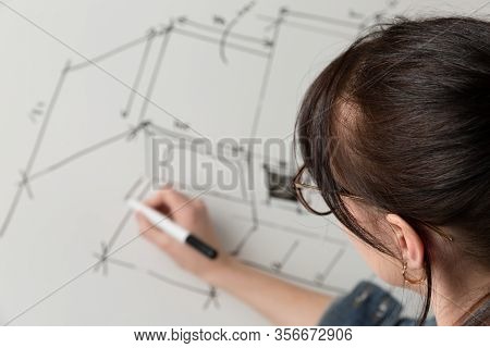 Close-up Of A Young Female Architect Drawing A Sketch For A New Famaly Home Project. Concept Of Work