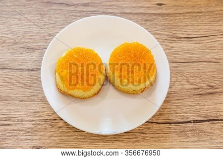 Shredded Egg Yolk Bread (foi Tong Thai) In A White Plate Placed On A Wooden Table