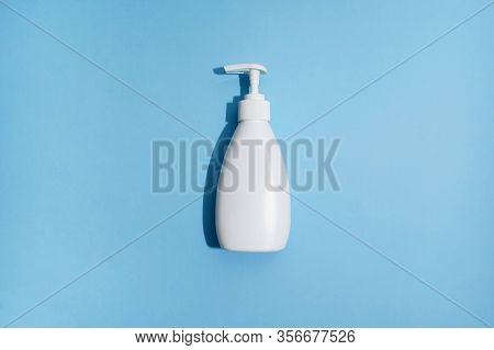White Plastic Bottle On Blue Background. Mockup. Flat Lay. Sanitizer Gel For Prevention Of Virus. Co