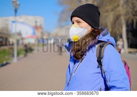 A Man In A Protective Medical Mask Stands On A Street In Germany. Epidemic Of Coronavirus In Germany