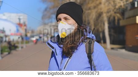 A Man In A Protective Medical Mask Stands On A Street In Germany. Epidemic Of Coronavirus In Germany
