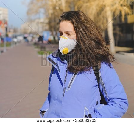 A Man In A Protective Medical Mask Stands On A Street In Germany. Epidemic Of Coronavirus In Germany