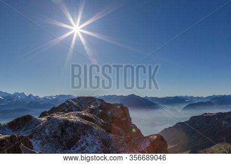 Niederhorn And Bernese Mountains In Switzerland With Lake Thun In Sunlight