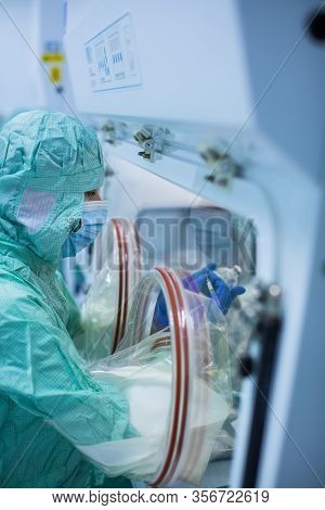 Virus antidote being prepared in a biochem lab with extremely strict precautionary measures (shallow DOF; color toned image)