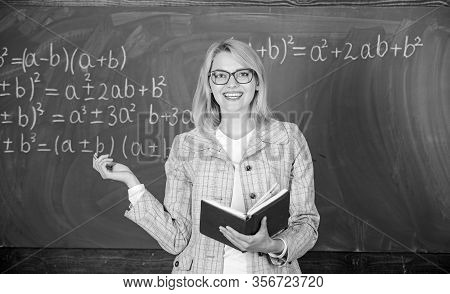 Effective Teaching Involve Acquiring Relevant Knowledge. Woman Teaching Near Chalkboard In Classroom