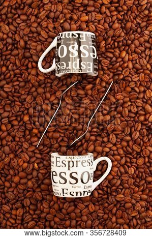 Two Cups Of Coffee On A Table Full Of Coffee Beans.  Coffee Design.