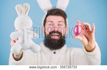 All Life Comes From An Egg. Celebration Of Spring Time Holiday. Hipster With Long Rabbit Ears Holdin