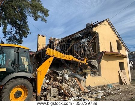 Ruined, Brick, Residential Building. The Ruins Of A Collapsed Mansion In The Forest. Demolition Of A
