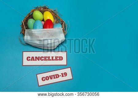 The Concept Of Canceling Events Due To The Covid-19 Coronavirus Pandemic. A Medical Mask, A Nest Wit