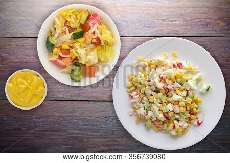 Crab Salad On A White Plate With Vegetarion Salad. Crabs Salad On A Purple Wooden Background Top Vie