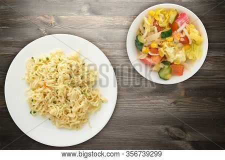 Vermicelli On A White Plate On Black Wooden Background. Vermicelli On A Plate With Vegetarion Salad 
