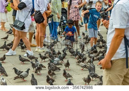 St. Mark Square, Venice, Italy - August 02, 2019: Warm Sunny Summer Day. Numerous Tourists Are Photo