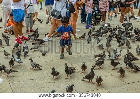 St. Mark Square, Venice, Italy - August 02, 2019: Warm Sunny Summer Day. Numerous Tourists Are Photo