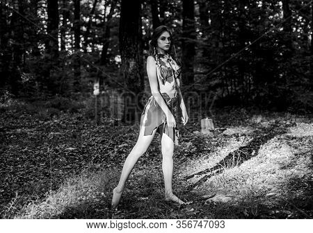 Female Spirit Mythology. Wild Woman In Forest. Sexy Girl Early Stage In The Evolutionary Development
