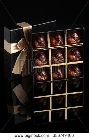 Heart Shaped Painted Luxury Handmade Bonbons In A Gift Box On A Black Background. Chocolates For Val