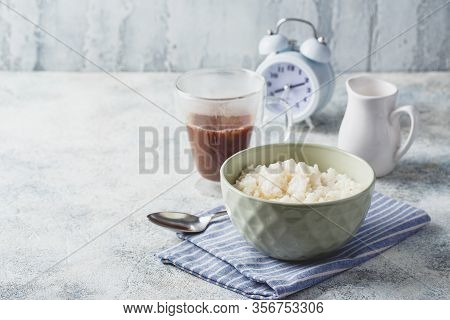 Breakfast With Milk Rice Porridge, Creamy Rice Pudding Or French Riz Au Lait In A Bowl, Glass Cup Wi