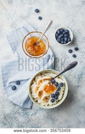 Breakfast With Milk Rice Porridge With Banans, Blueberry And Orange Jam, Creamy Rice Pudding Or Fren