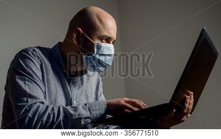 Caucasian Man Wearing Protective Standard Ffp1 Antiviral Face Mask And Working At Home With Laptop