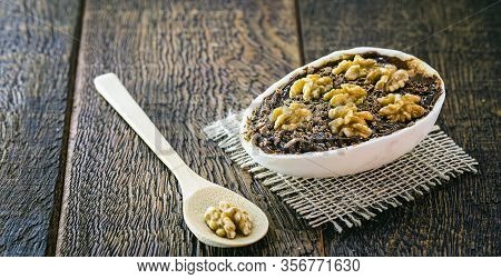 Chocolate Egg And Walnuts With Filling For Easter On Wooden Background. Brazilian Easter Egg, Brazil