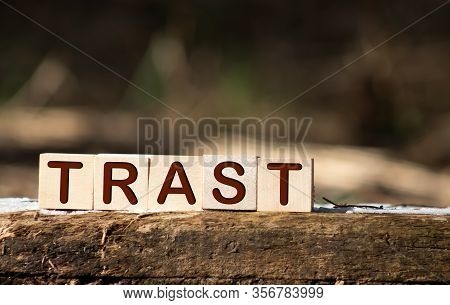 The Concept Of The Word Trast On Cubes Against The Background Of The Graph