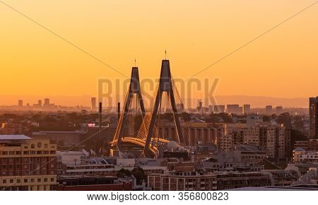 Close Up Aerial View Of Anzac Bridge In Sydney, During Sunset Time With Buildings In Background.  Th