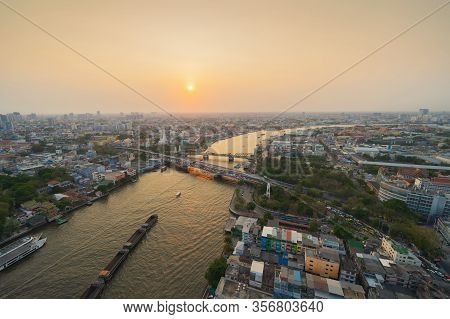 Aerial View Of White Prayoon Pagoda, Memorial Bridge, And Phra Pok Klao Bridge With Buildings And Cu