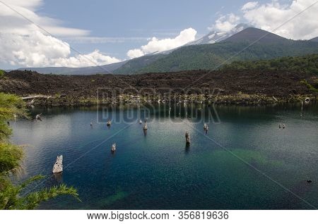 Arco Iris Lagoon And Llaima Volcano Covered By Clouds. Conguillio National Park. Araucania Region. C