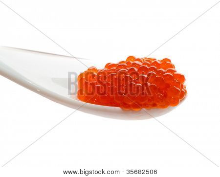 Red caviar on the spoon, on white background