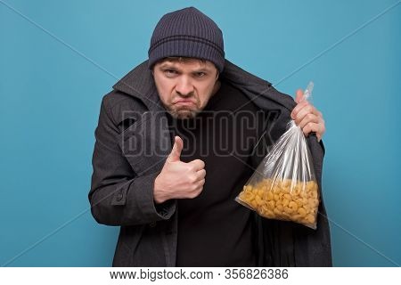 Smuggler Selling Food. Dealer In Hat And Coat Offering To Buy Pasta. Deficit Of Food Because Of Pani