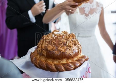 The Bride And Groom Break The Wedding Loaf.