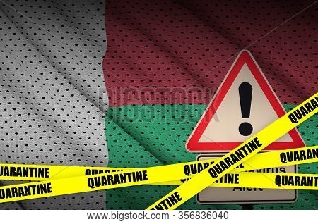 Madagascar Flag And Covid-19 Quarantine Yellow Tape. Coronavirus Or 2019-ncov Virus